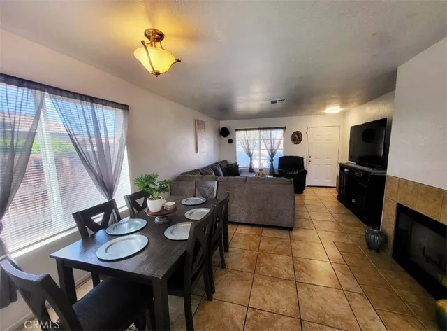 a living room with furniture a flat screen tv and a large window
