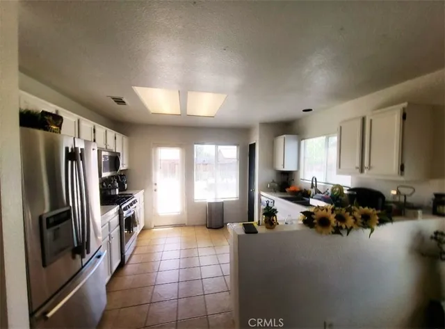 a kitchen with stainless steel appliances a refrigerator and a counter top space