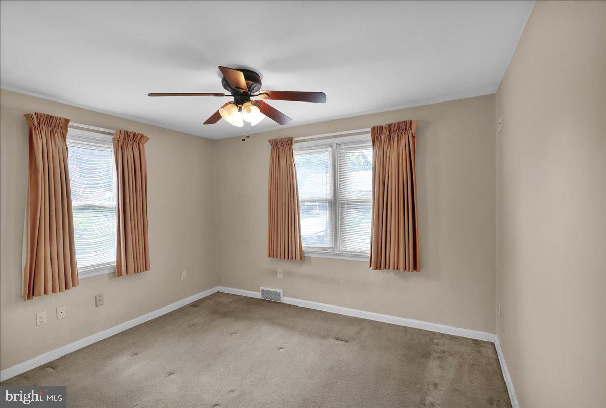 27 Woodland Road Reading, PA 19610 - Photo 12 of 34 an empty room with windows and fan