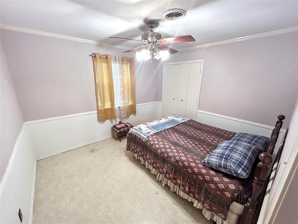 4905 Rippy Road Flower Mound, TX 75028 - Photo 19 of 29 Bedroom featuring crown molding, ceiling fan, a closet, and carpet