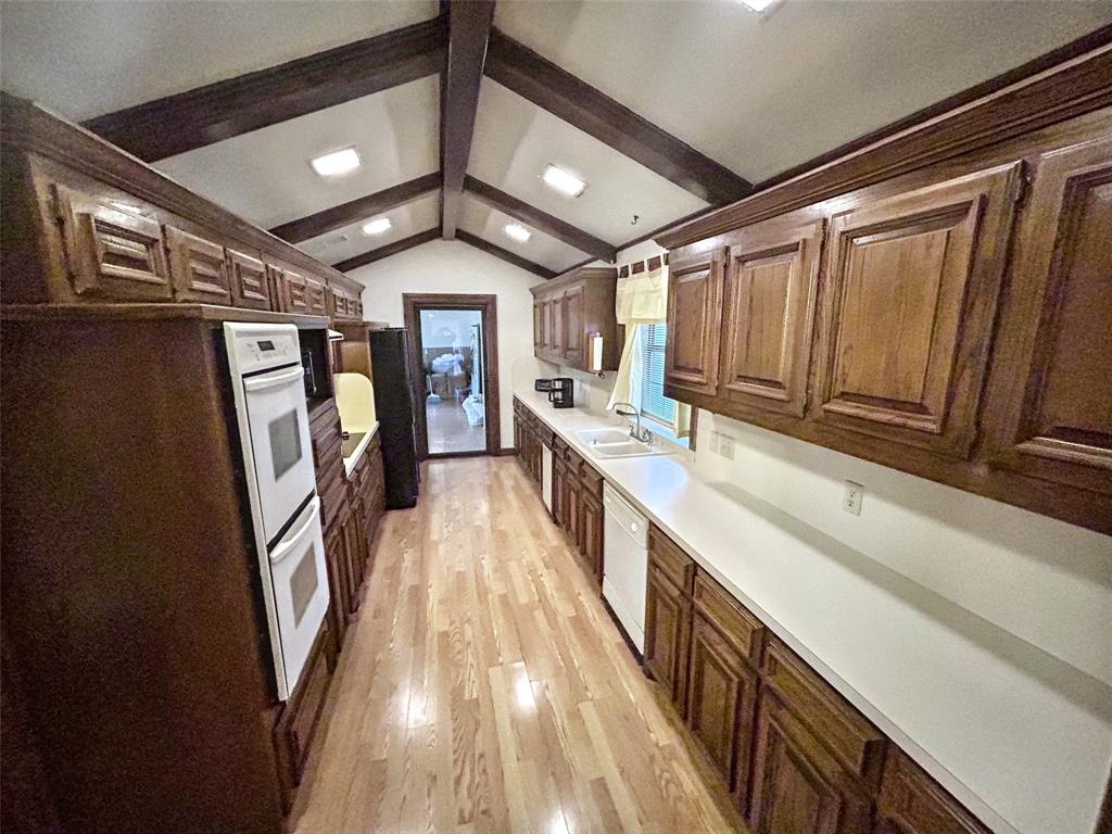 4905 Rippy Road Flower Mound, TX 75028 - Photo 22 of 29 Kitchen with a sink, light wood-type flooring, white appliances, light countertops, and recessed lighting