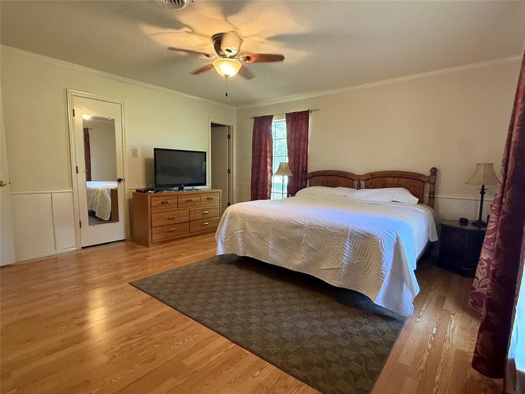 4905 Rippy Road Flower Mound, TX 75028 - Photo 27 of 29 Bedroom with wood finished floors, ornamental molding, and ceiling fan