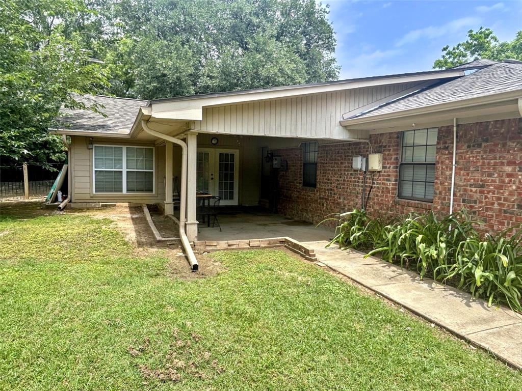 4905 Rippy Road Flower Mound, TX 75028 - Photo 3 of 29 View of front of home featuring a shingled roof, a patio, and brick siding