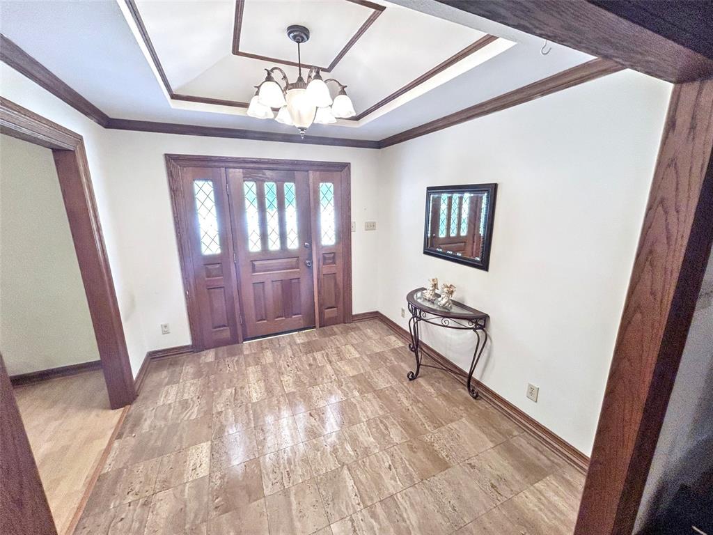 4905 Rippy Road Flower Mound, TX 75028 - Photo 4 of 29 Foyer entrance featuring a tray ceiling, a chandelier, baseboards, and ornamental molding