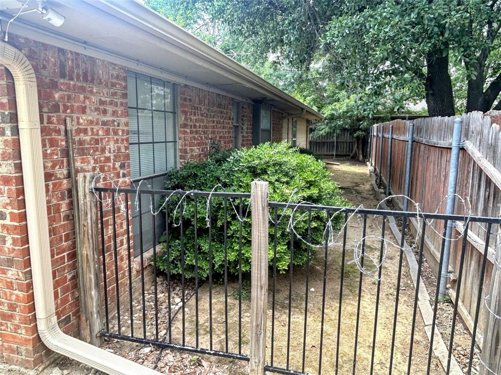 4905 Rippy Road Flower Mound, TX 75028 - Photo 5 of 29 View of home's exterior with a fenced backyard and brick siding