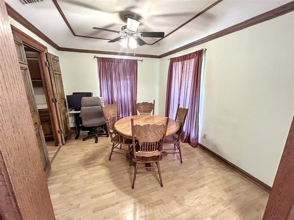 4905 Rippy Road Flower Mound, TX 75028 - Photo 6 of 29 Dining room featuring a ceiling fan, light wood-style floors, an office area, a raised ceiling, and ornamental molding