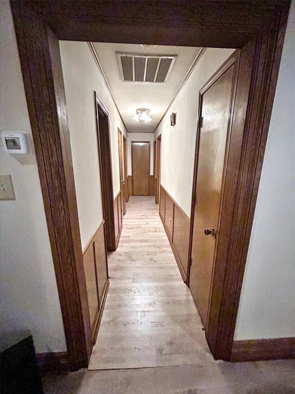4905 Rippy Road Flower Mound, TX 75028 - Photo 7 of 29 Hall with a wainscoted wall, light wood-style floors, and crown molding