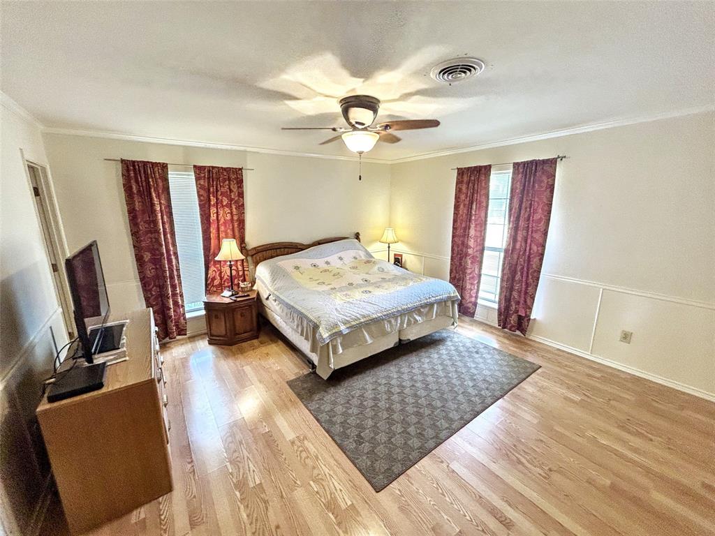 4905 Rippy Road Flower Mound, TX 75028 - Photo 9 of 29 Bedroom with ornamental molding, light wood-style flooring, and a ceiling fan
