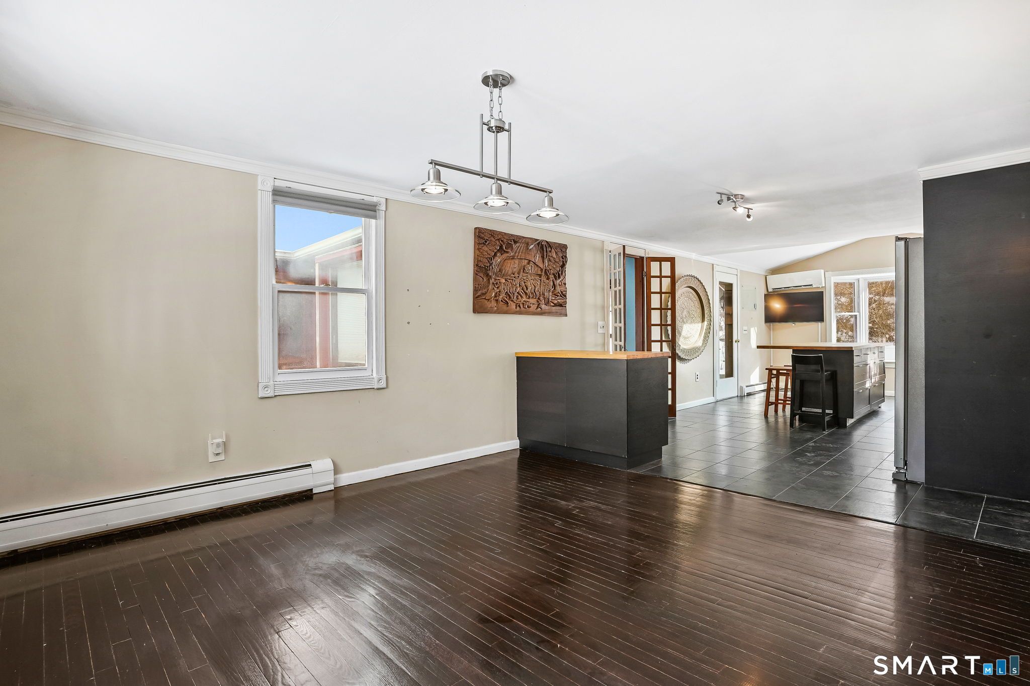 12 Skidmore Lane Sandy Hook, CT 06482 - Photo 8 of 27 a view of a livingroom with wooden floor and kitchen space with furniture