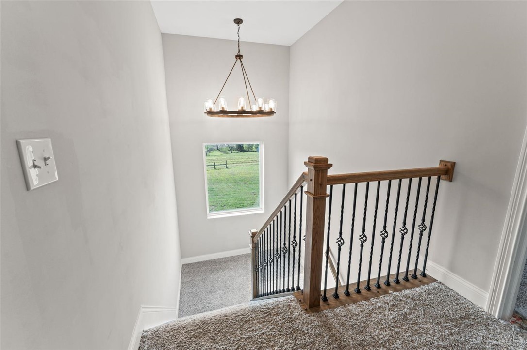 2425 Middleboro Road Clarksville, OH 45113 - Photo 54 of 91 Grand staircase featuring intricate wrought iron railings and natural light.