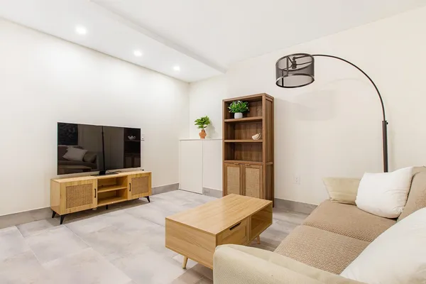 a living room with furniture and a flat screen tv
