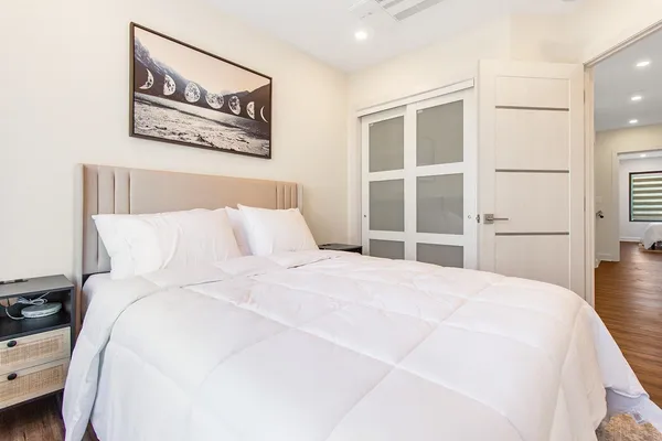 a large white bed in a white room