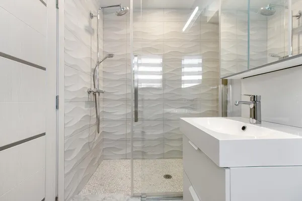 a bathroom with a sink and shower