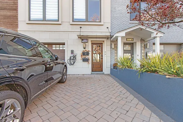 a view of a house with a cars park side of a road