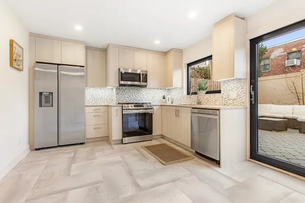 a kitchen with stainless steel appliances a refrigerator sink and stove