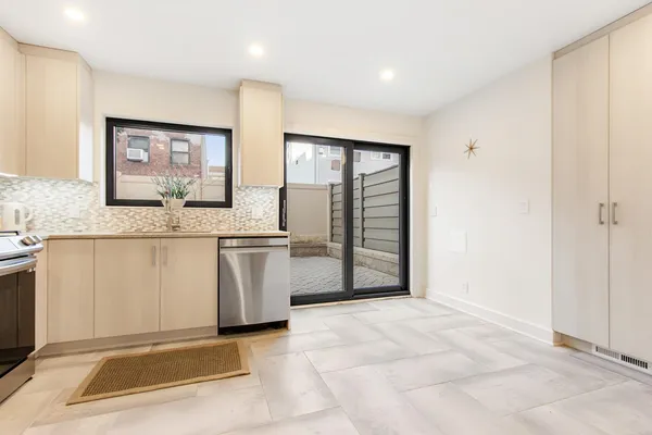 a view of kitchen with granite countertop cabinets and outdoor space