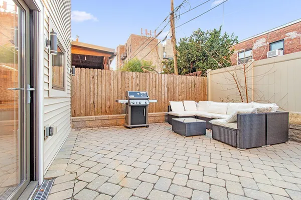 a view of a patio with table and chairs