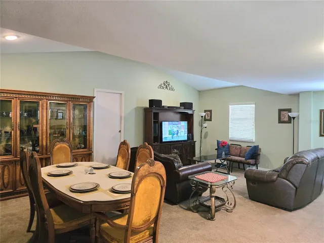 a living room with furniture a rug and a window