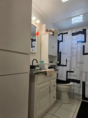 a view of bathroom with toilet sink and mirror