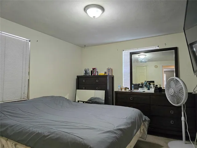 a bedroom with a bed and a closet