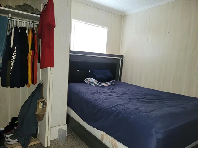 a bedroom with a bed and a window