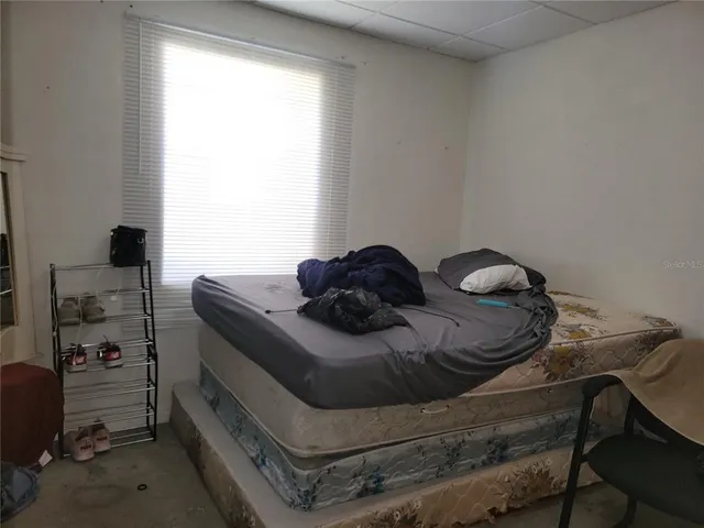 a bedroom with a bed and a chair