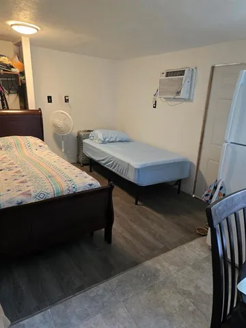 a bedroom with two beds and a table in it