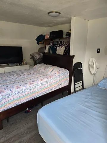 a bedroom with a bed and a television