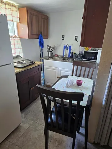 a kitchen with a wooden table and cabinets