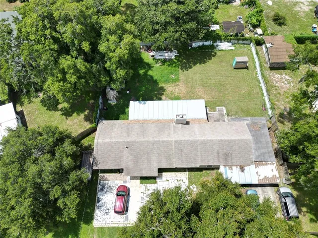 an aerial view of a house with a yard