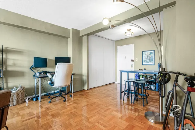 a living room with furniture a flat screen tv and a window