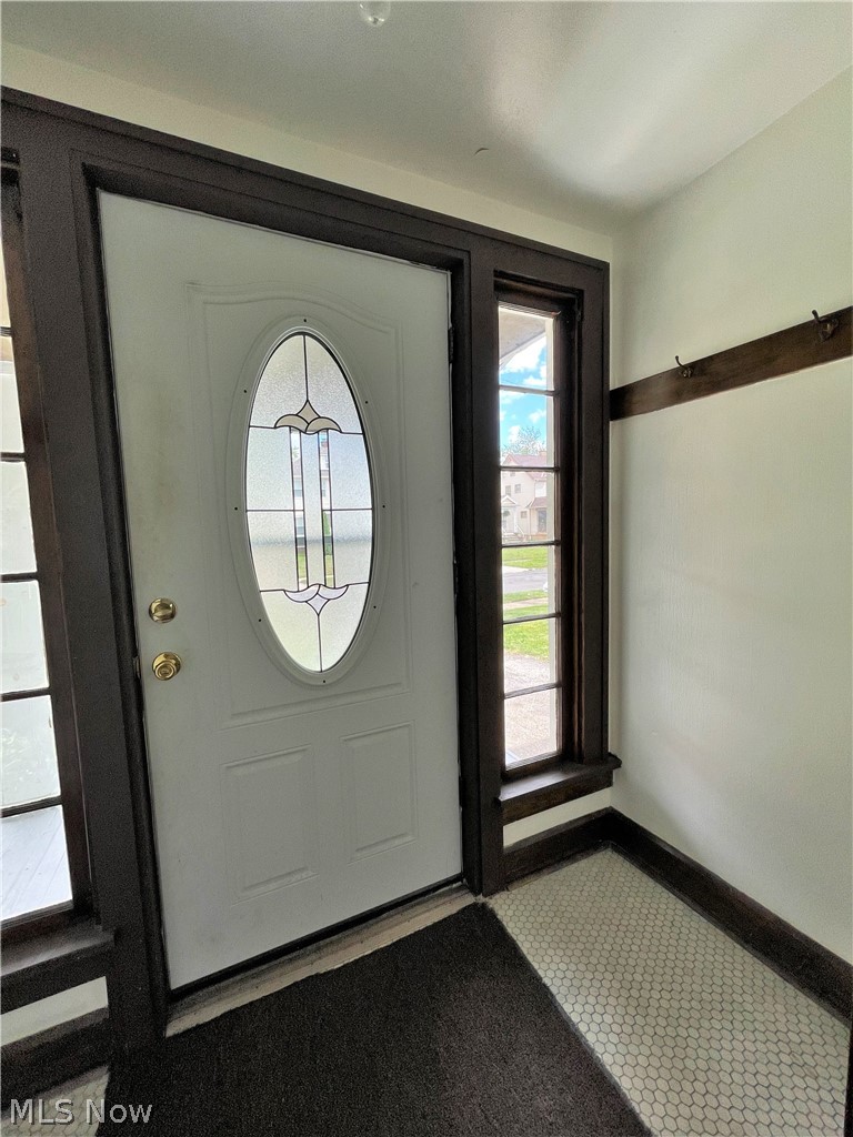 2104 Rossmoor Road Cleveland Heights, OH 44118 - Photo 28 of 35 Foyer with newer door and original tile floor and an hooks to hang your jackets.