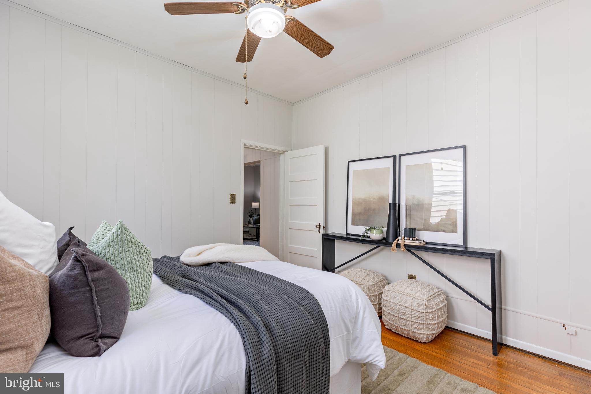 6426 Sherwood Road Baltimore, MD 21239 - Photo 18 of 43 a bedroom with a bed and wooden floor