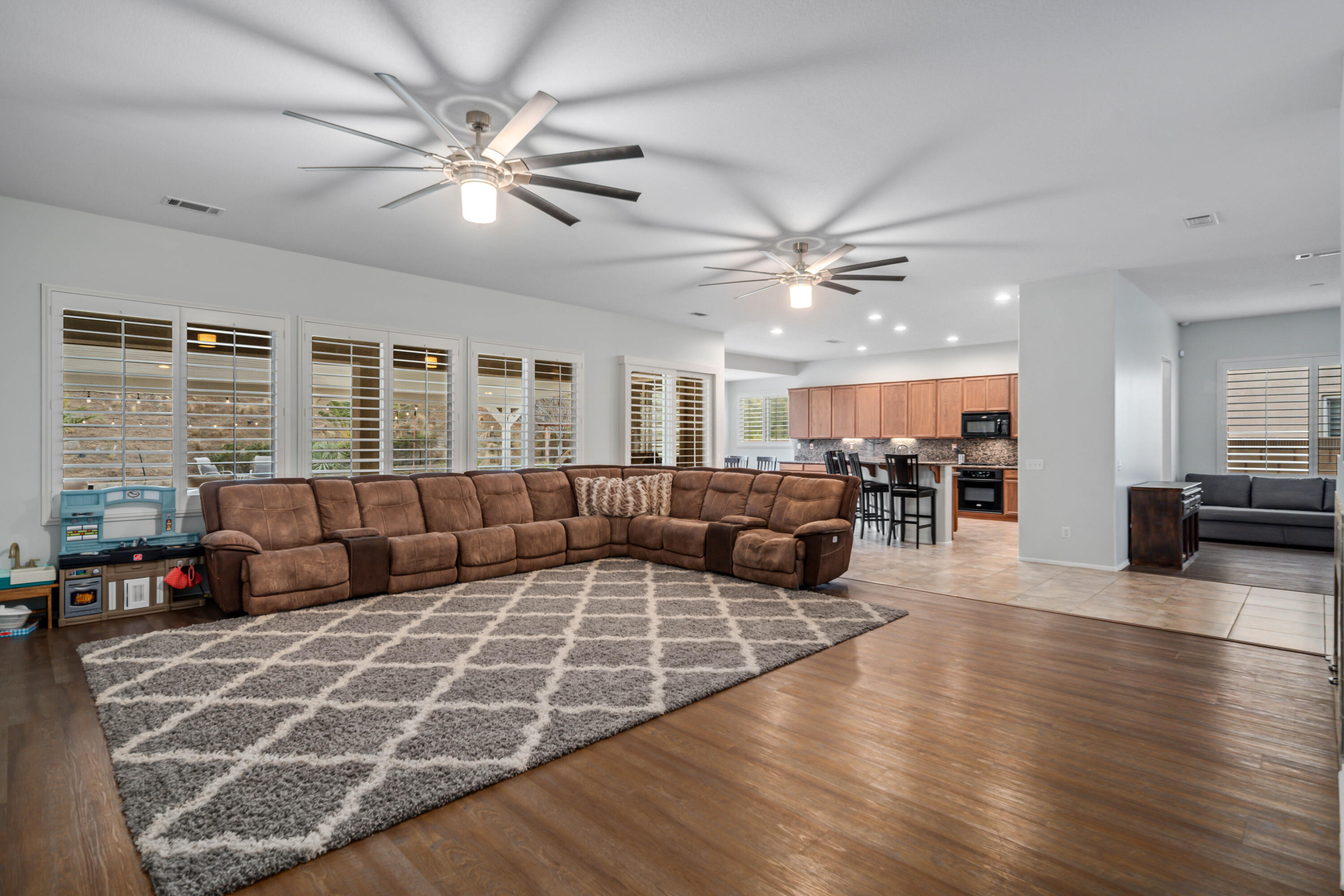 40467 Tiger Way Palmdale, CA 93551 - Photo 17 of 60 a living room with furniture large window and wooden floor
