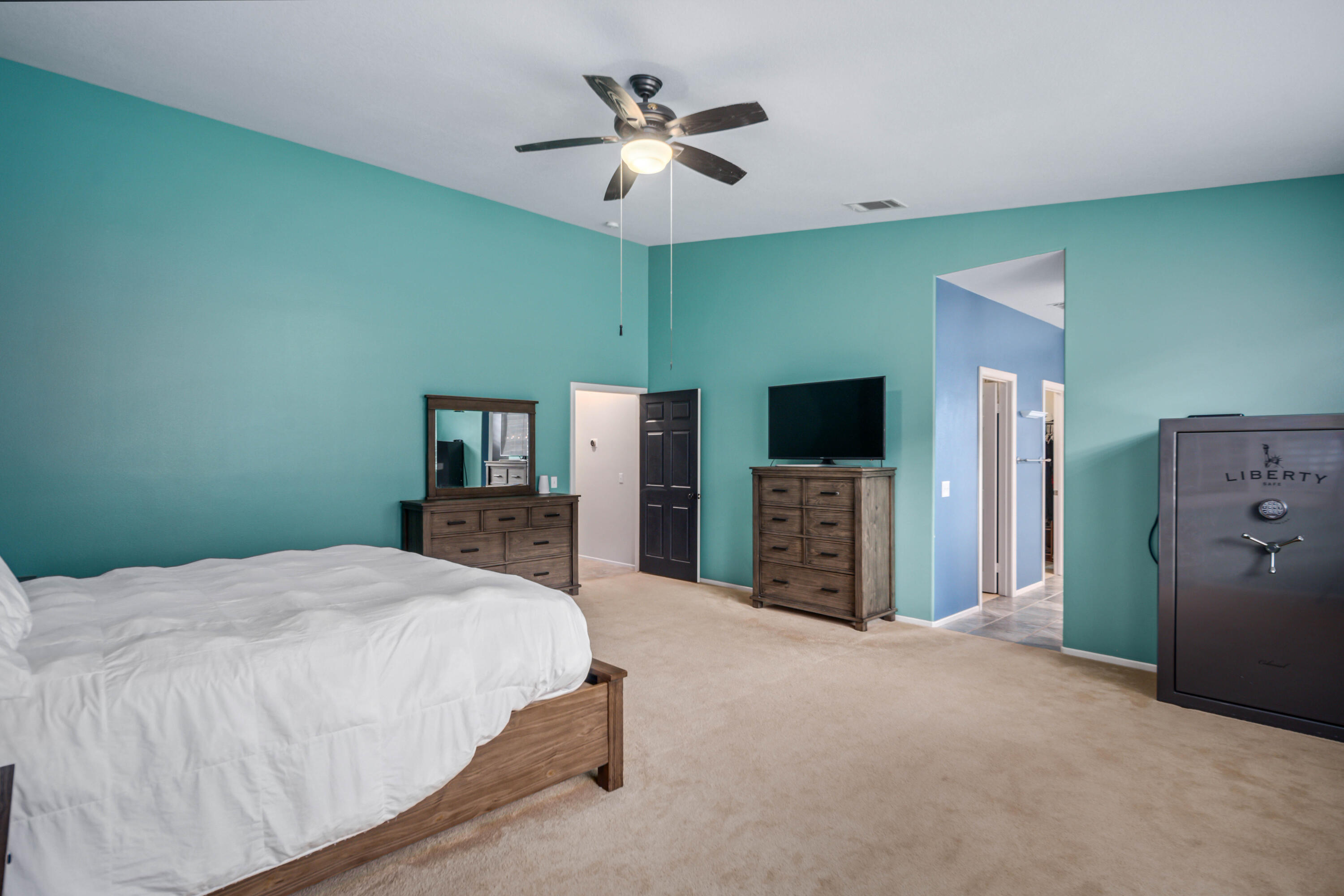 40467 Tiger Way Palmdale, CA 93551 - Photo 23 of 60 a spacious bedroom with a bed and a flat screen tv
