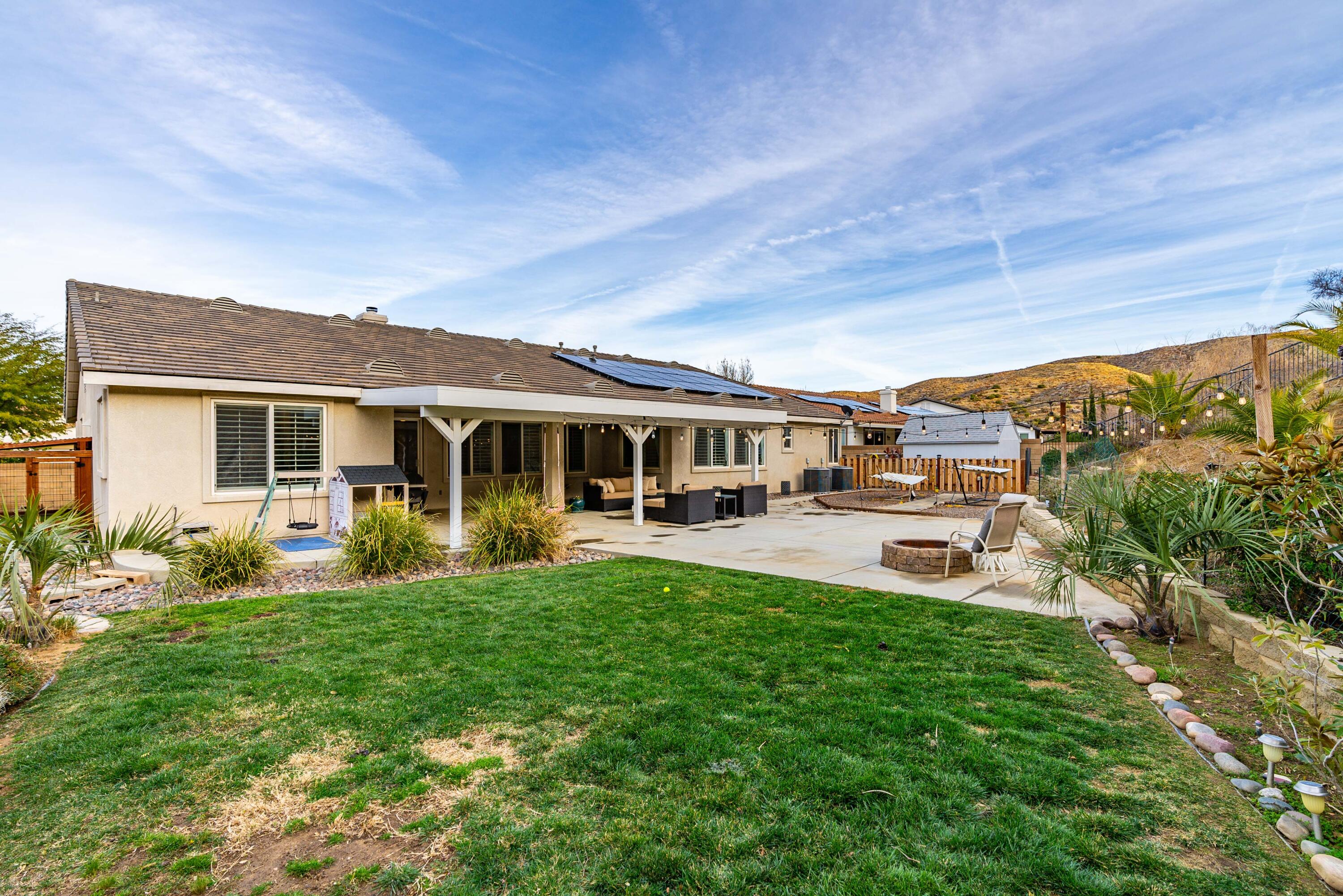 40467 Tiger Way Palmdale, CA 93551 - Photo 49 of 60 a view of a house with backyard sitting area and garden
