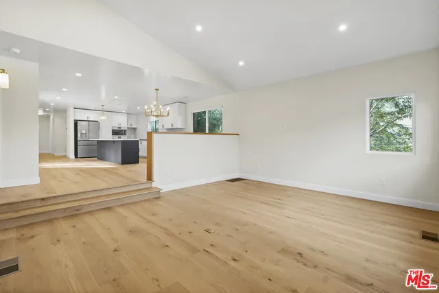 a view of kitchen and hall with wooden floor