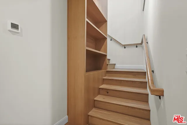 an empty room with wooden floor and window