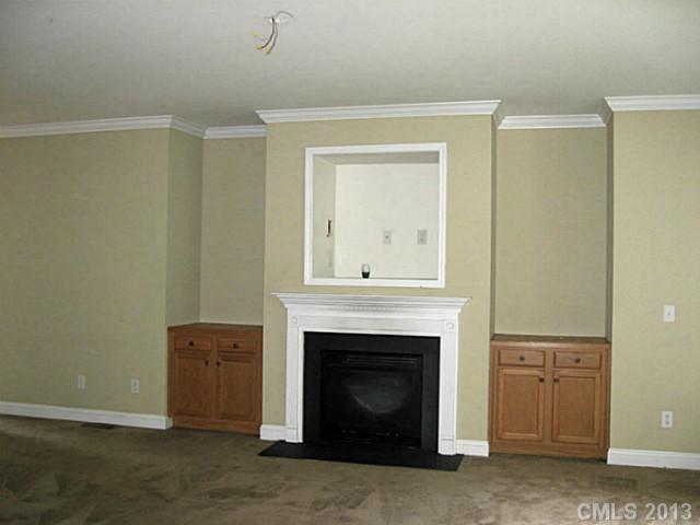 5727 Charing Place Charlotte, NC 28211 - Photo 2 of 15 a view of an empty room with a fireplace and a window