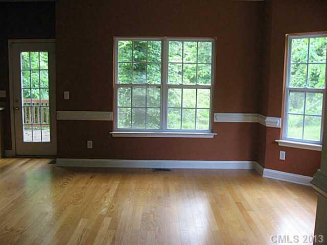 5727 Charing Place Charlotte, NC 28211 - Photo 4 of 15 an empty room with wooden floor and windows