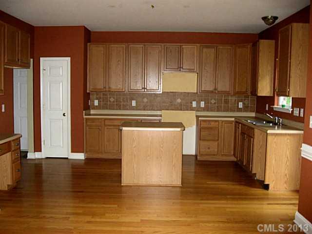 5727 Charing Place Charlotte, NC 28211 - Photo 5 of 15 a kitchen with stainless steel appliances granite countertop a stove top oven a sink and a refrigerator