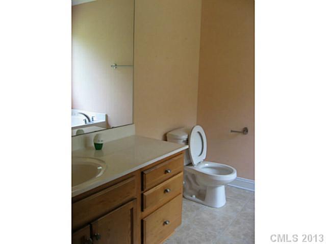 5727 Charing Place Charlotte, NC 28211 - Photo 10 of 15 a bathroom with a toilet sink and mirror