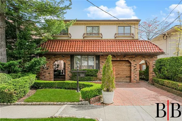 a front view of a house with garden