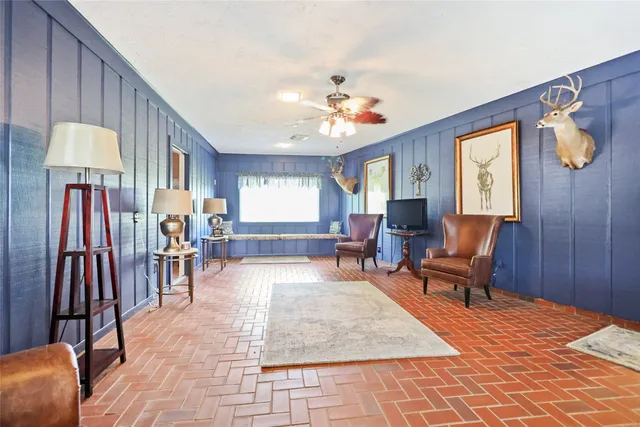 a living room with furniture and a dining table
