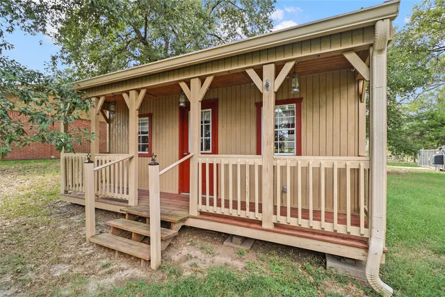 a view of a house with backyard and trees