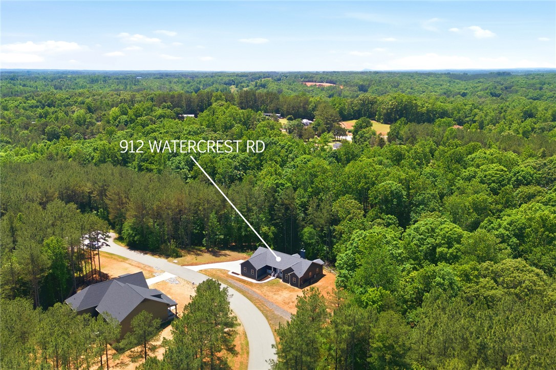 912 Watercrest Road West Union, SC 29696 - Photo 45 of 49 An aerial perspective reveals a secluded residence nestled amidst a vibrant, green forest landscape.