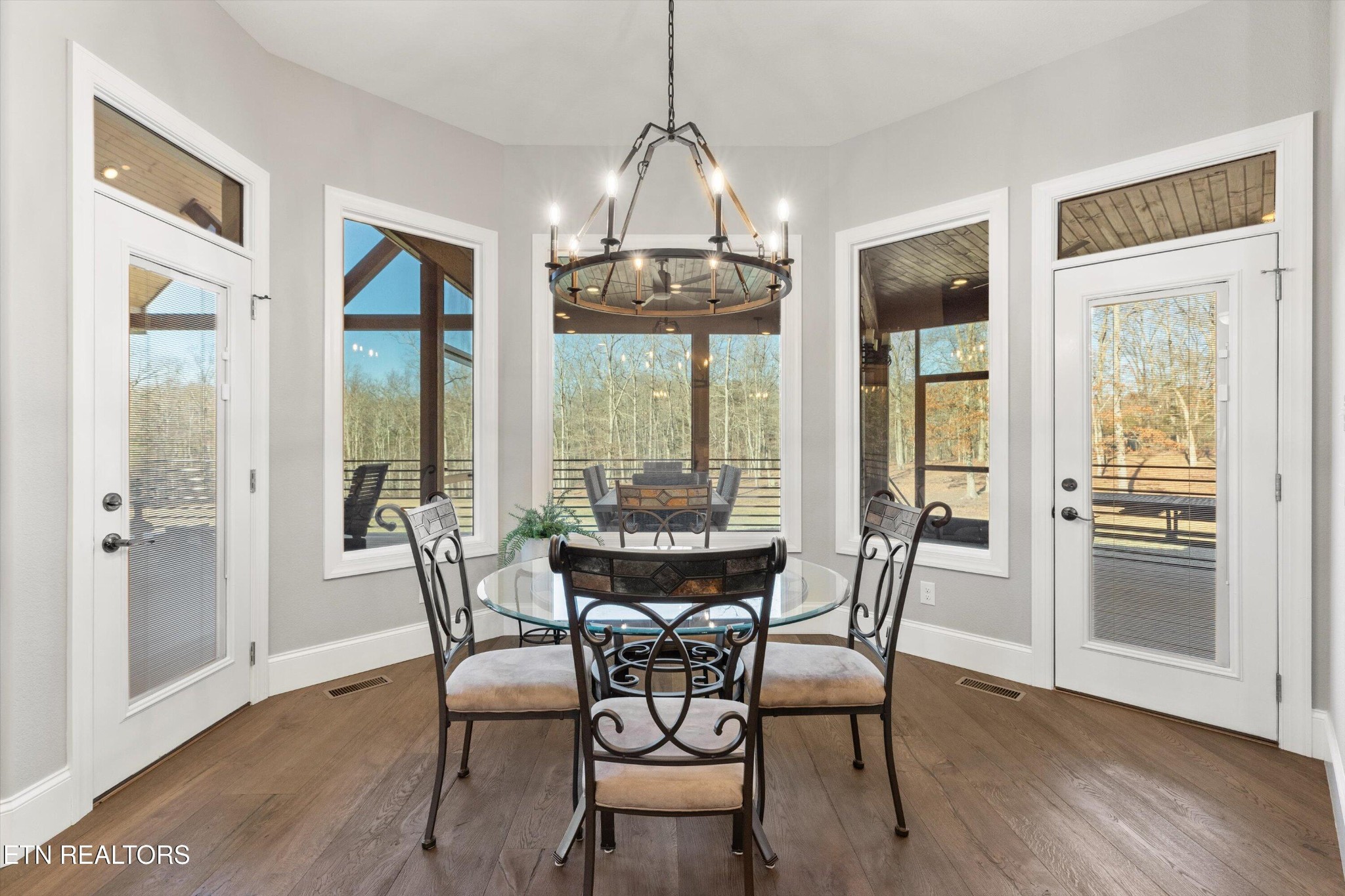 1752 Hillendale Road Crossville, TN 38572 - Photo 24 of 60 a view of a dining room with furniture large windows and wooden floor