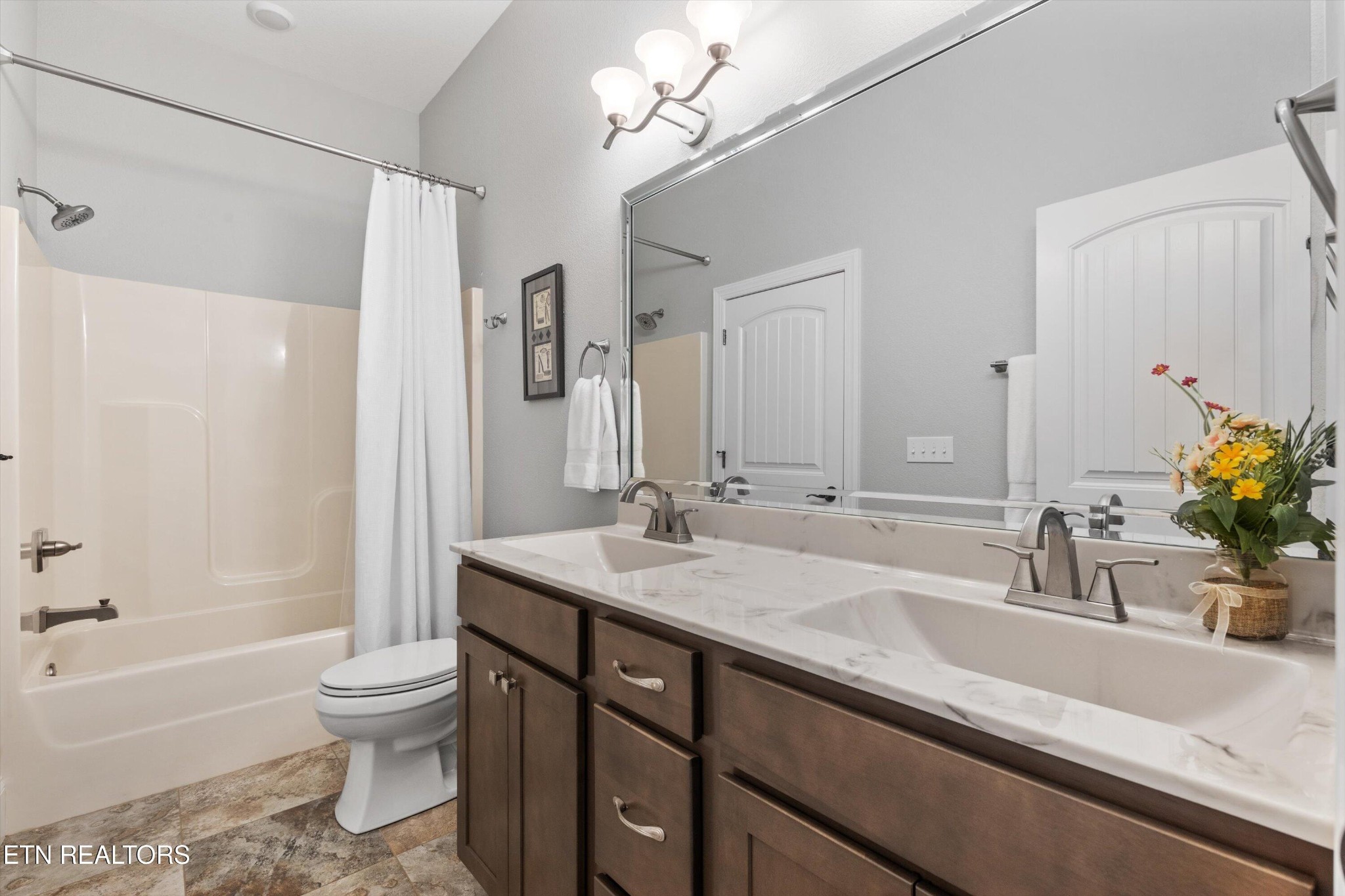 1752 Hillendale Road Crossville, TN 38572 - Photo 28 of 60 a bathroom with a granite countertop sink a toilet a mirror a bathtub and shower