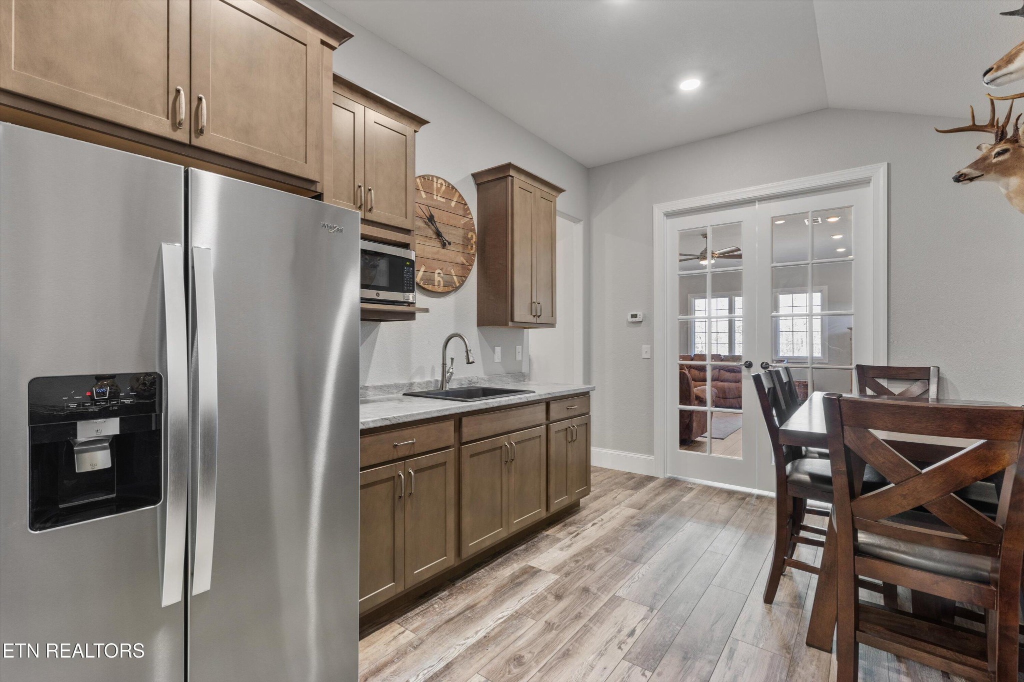 1752 Hillendale Road Crossville, TN 38572 - Photo 33 of 60 a kitchen with stainless steel appliances granite countertop a refrigerator a sink a stove and white cabinets with wooden floors