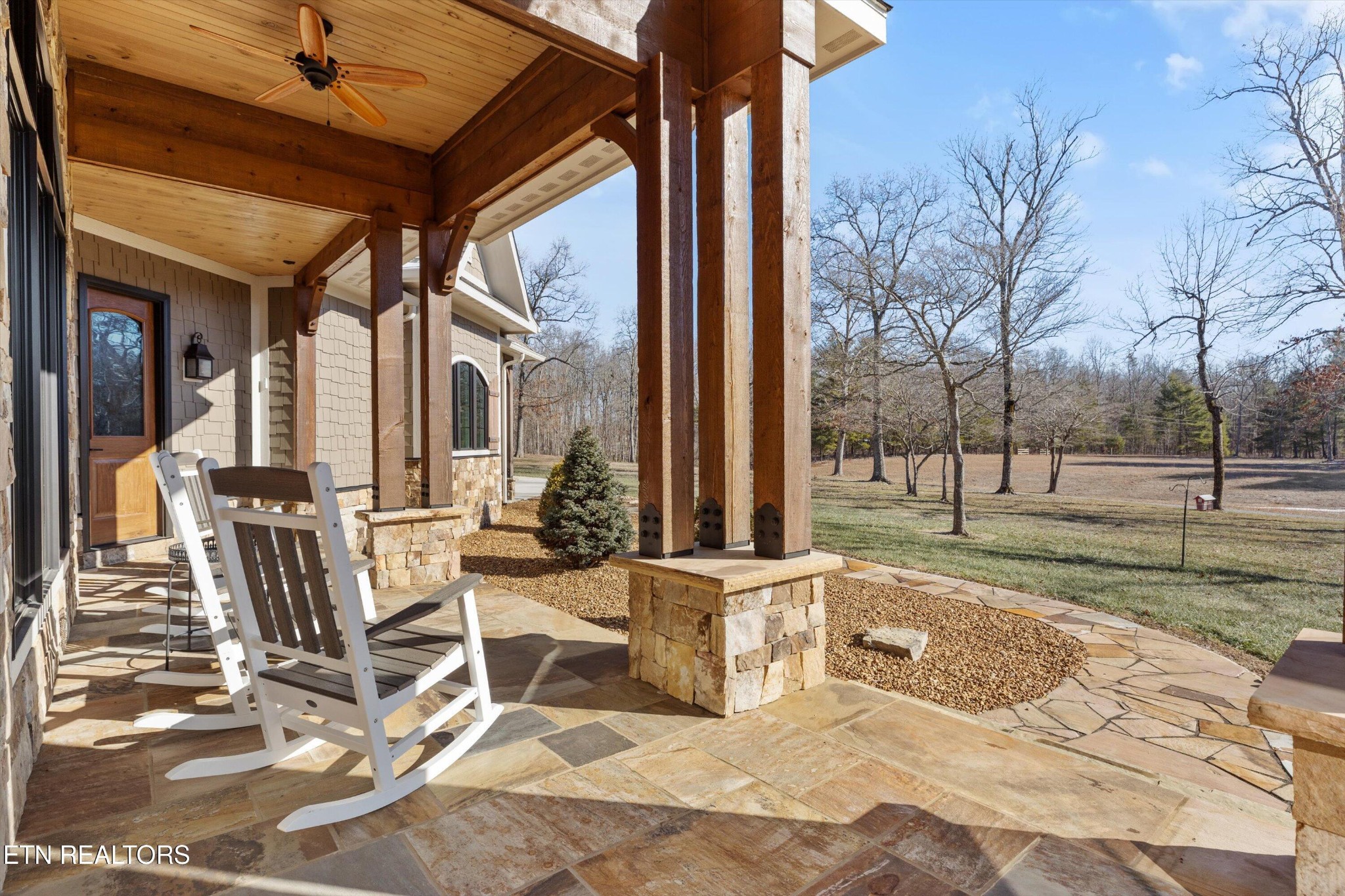 1752 Hillendale Road Crossville, TN 38572 - Photo 58 of 60 a view of a patio with table and chairs and floor to ceiling window
